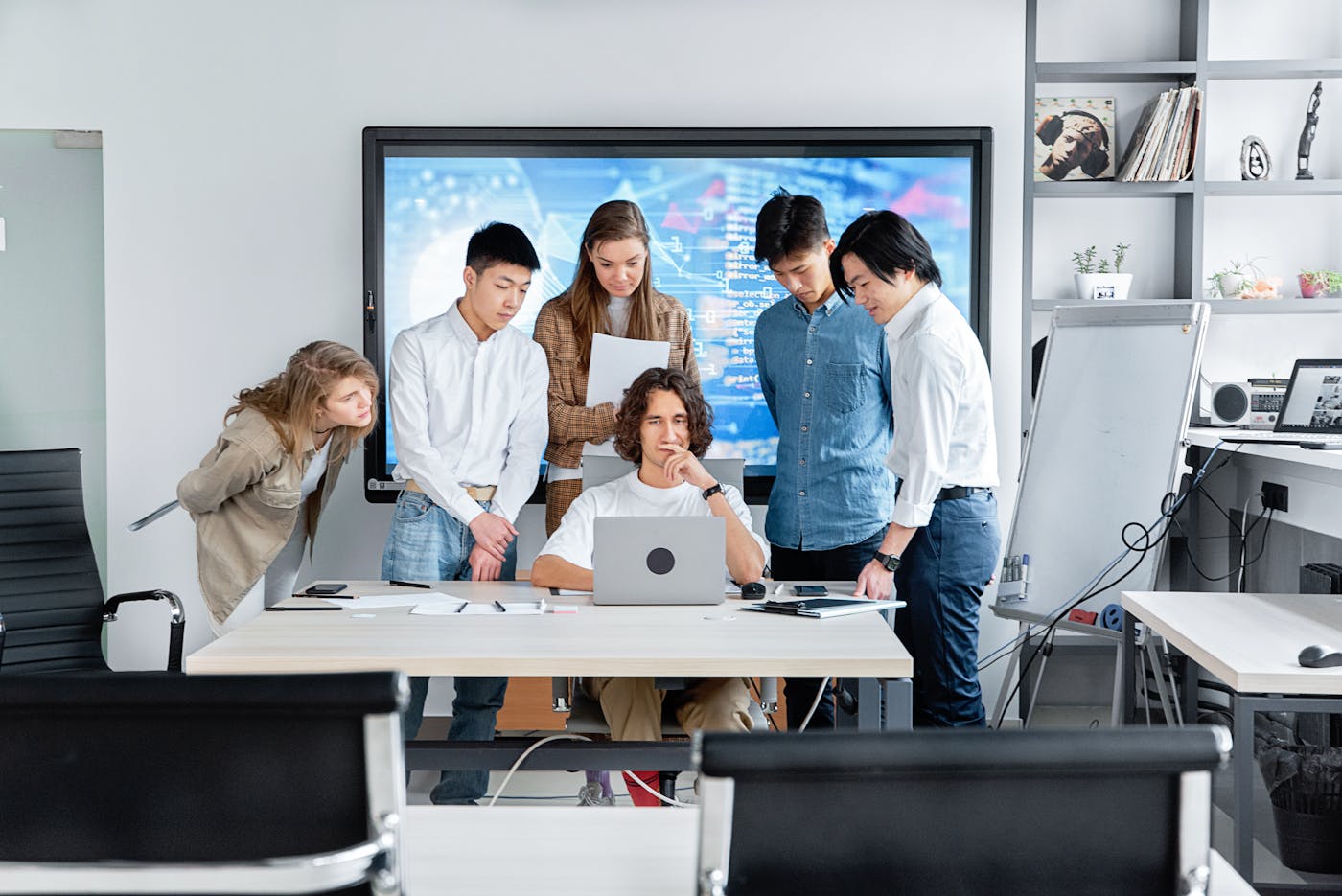 Technology team reviewing software work on a laptop screen